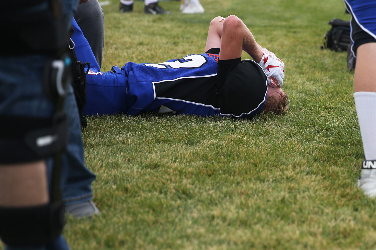 Ethan Devlin lays on the ground in pain after limping off the field